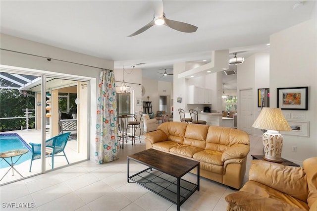 living room with ceiling fan and light tile patterned floors