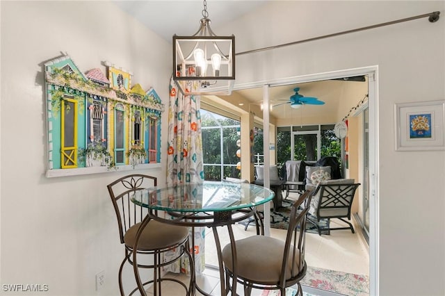 dining room featuring ceiling fan with notable chandelier