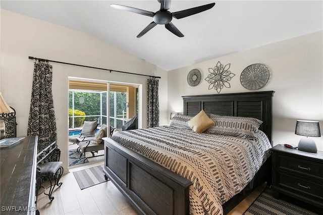 bedroom featuring ceiling fan, access to exterior, light hardwood / wood-style flooring, and vaulted ceiling