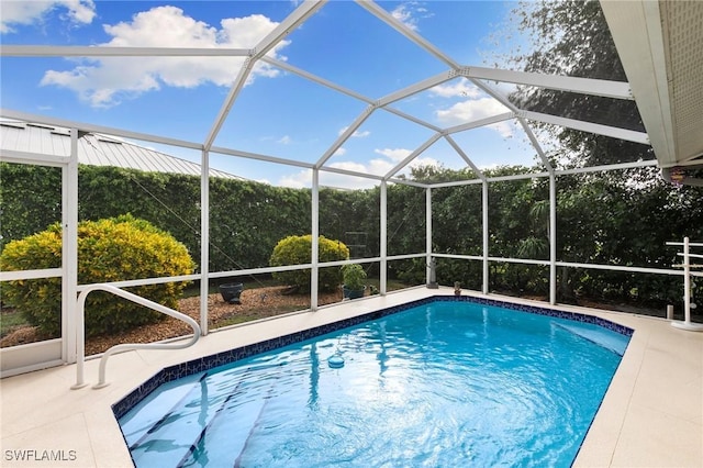 view of swimming pool featuring glass enclosure