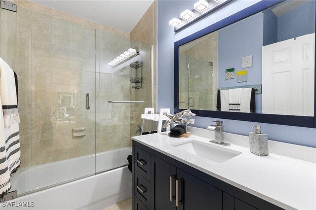 bathroom featuring vanity and enclosed tub / shower combo