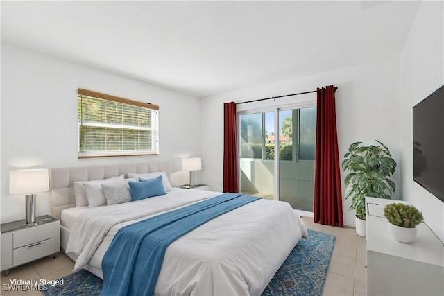 bedroom featuring light tile patterned flooring and access to outside