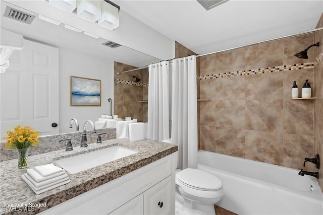 bathroom with shower / tub combo, visible vents, vanity, and toilet