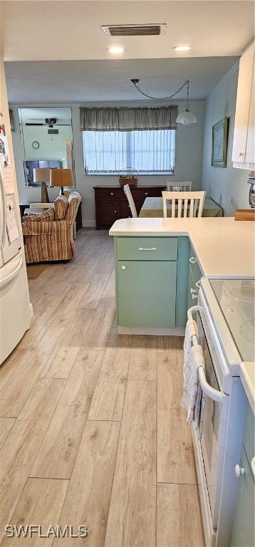 kitchen with white appliances and light wood-type flooring