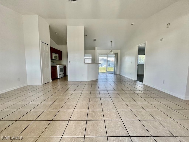 unfurnished living room featuring light tile patterned floors and high vaulted ceiling