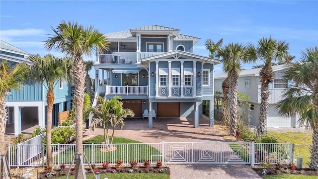 raised beach house with a balcony and a garage