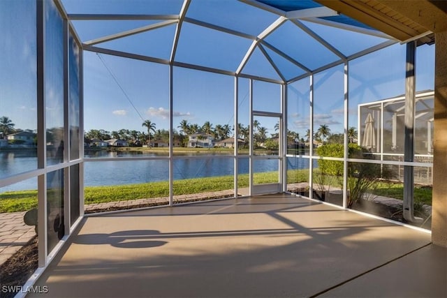 unfurnished sunroom with a water view