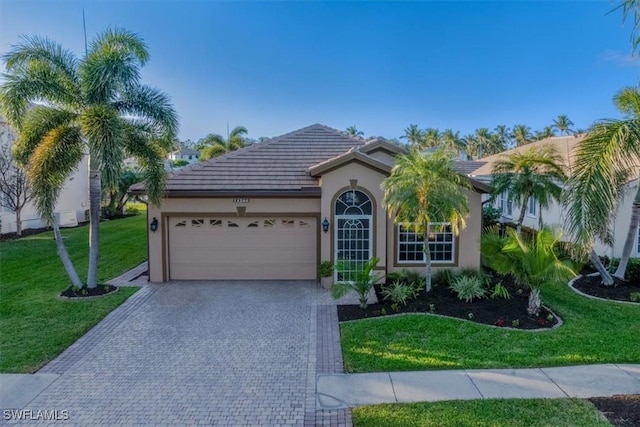 view of front of house with a garage and a front yard