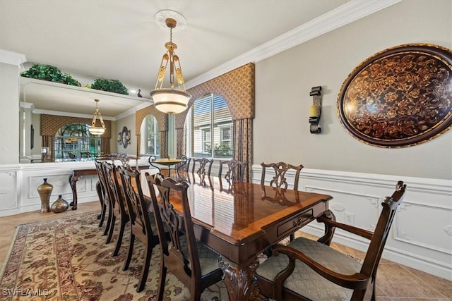 tiled dining area featuring crown molding