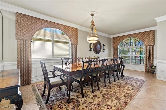 dining space with light tile patterned floors and ornamental molding