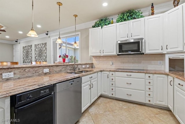 kitchen featuring appliances with stainless steel finishes, white cabinetry, tasteful backsplash, light stone countertops, and decorative light fixtures