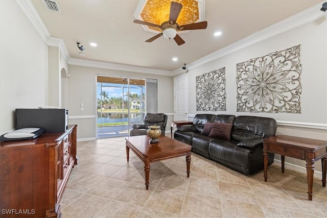 tiled living room featuring crown molding, ceiling fan, and a water view