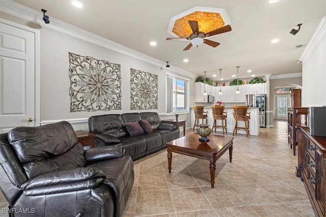 living room featuring crown molding and ceiling fan