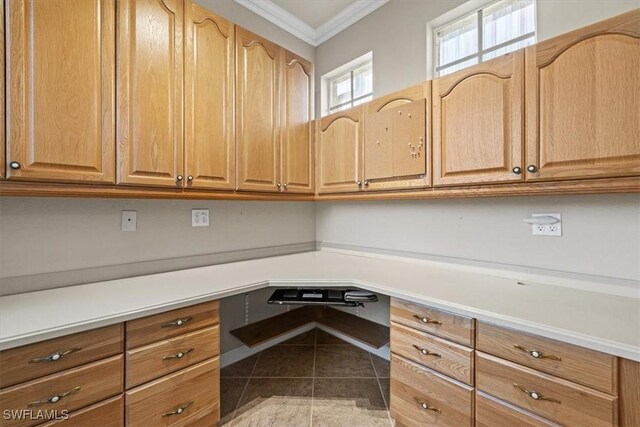 unfurnished office featuring ornamental molding and tile patterned floors