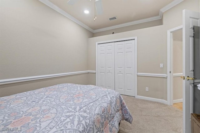 carpeted bedroom featuring crown molding, ceiling fan, and a closet