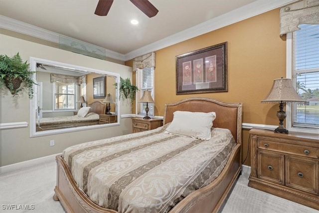 carpeted bedroom with ornamental molding and ceiling fan