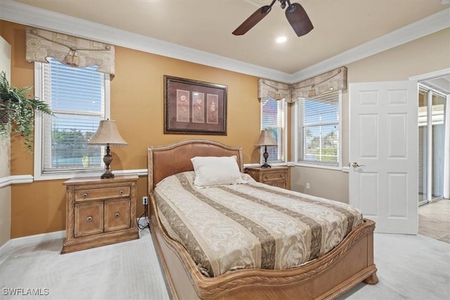 carpeted bedroom with ceiling fan and ornamental molding