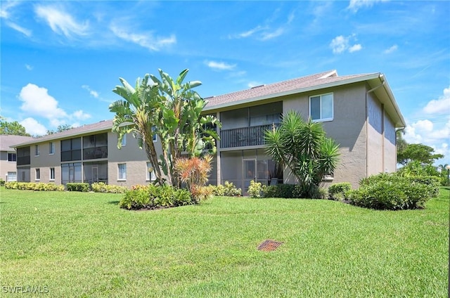 rear view of property featuring a yard