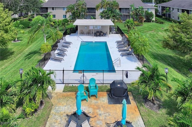 view of swimming pool with grilling area and a patio area