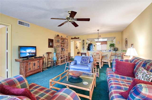 carpeted living room with ceiling fan