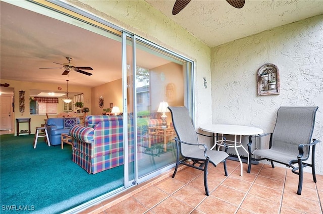 exterior space featuring ceiling fan