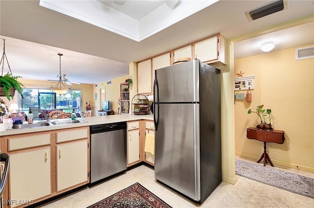 kitchen with pendant lighting, stainless steel appliances, and sink