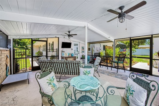 sunroom / solarium with vaulted ceiling with beams and ceiling fan