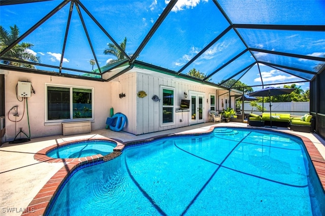 view of pool featuring a lanai, an in ground hot tub, a patio, and french doors