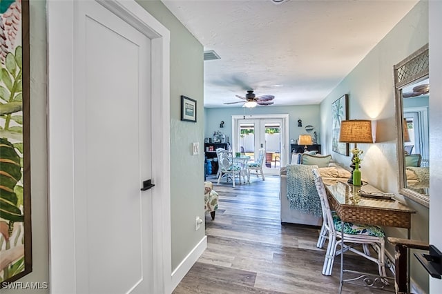 hallway with french doors and wood-type flooring