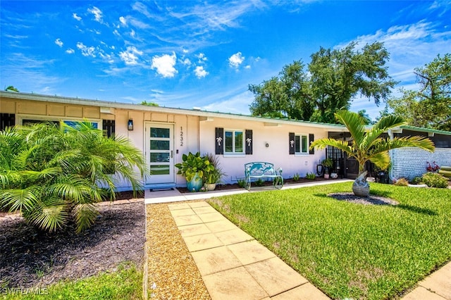 ranch-style home with a front lawn