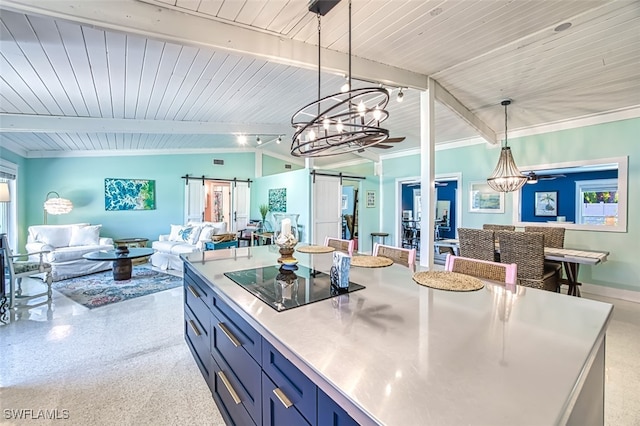 kitchen with black electric stovetop, a barn door, an inviting chandelier, vaulted ceiling with beams, and hanging light fixtures