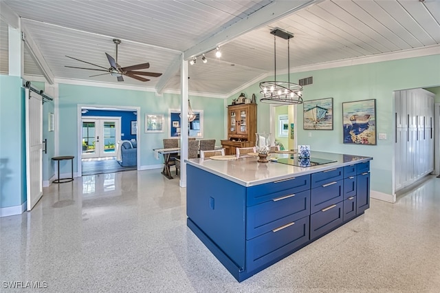 kitchen with a center island, lofted ceiling with beams, blue cabinets, crown molding, and decorative light fixtures