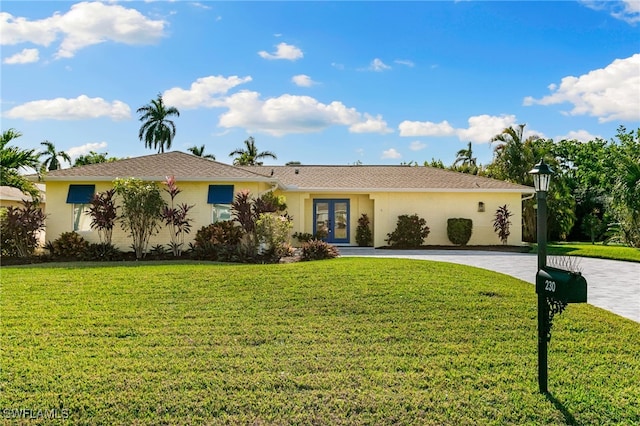 single story home with french doors and a front yard