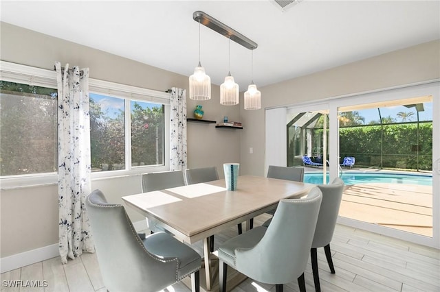 dining room with light hardwood / wood-style floors and plenty of natural light