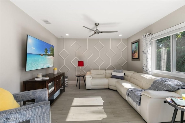 living room with ceiling fan and wood-type flooring