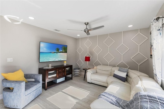 living room featuring ceiling fan and light hardwood / wood-style flooring