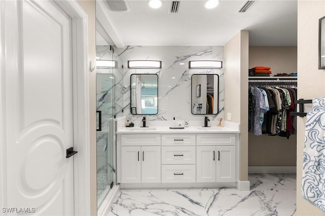 bathroom with vanity and a shower with door