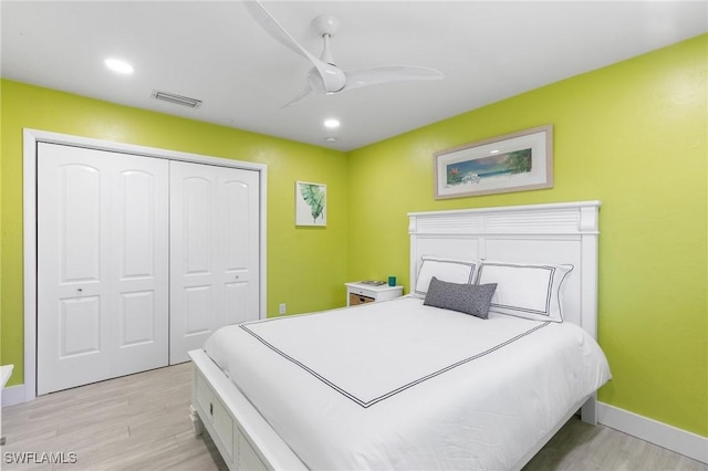 bedroom with a closet, ceiling fan, and light hardwood / wood-style floors