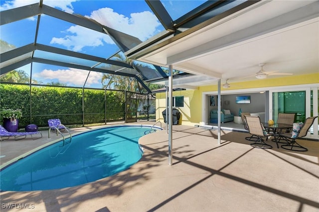 view of pool featuring ceiling fan, a lanai, and a patio