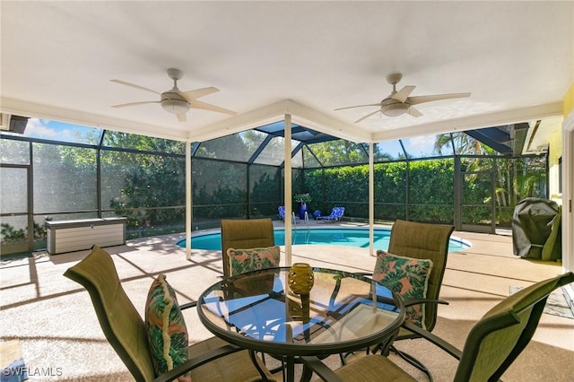 view of patio with ceiling fan, area for grilling, a lanai, and a swimming pool with hot tub