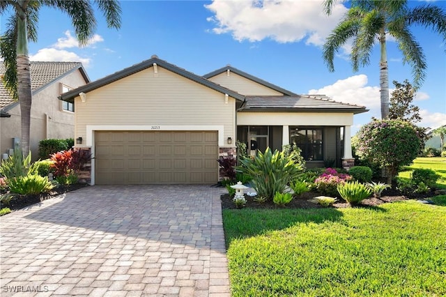 view of front facade with a garage and a front lawn