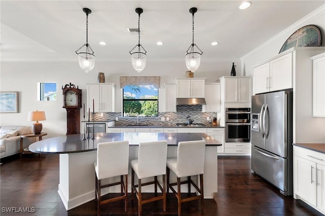 kitchen with pendant lighting, a center island, white cabinets, and stainless steel appliances