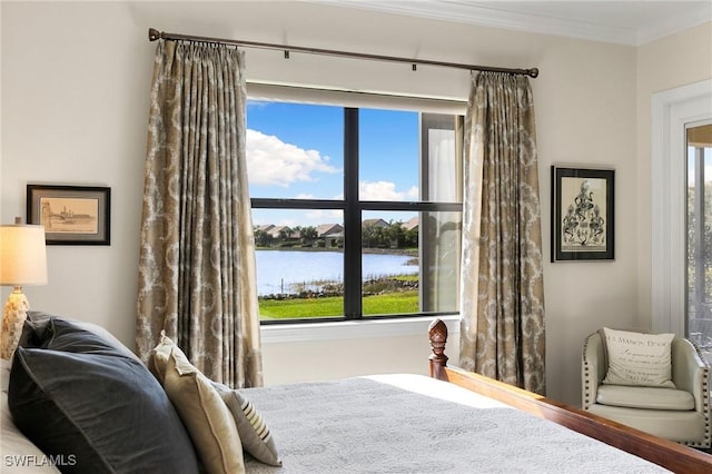 bedroom with a water view and crown molding