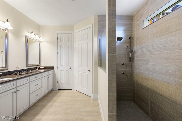 bathroom with vanity and tiled shower