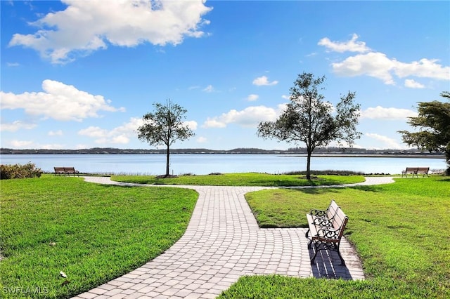 view of property's community featuring a yard and a water view