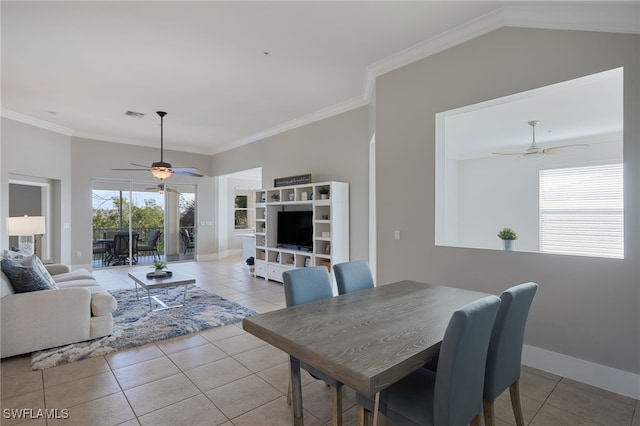 dining room featuring crown molding, light tile patterned floors, and ceiling fan