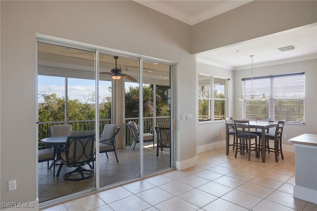 doorway to outside with ceiling fan, light tile patterned floors, and crown molding