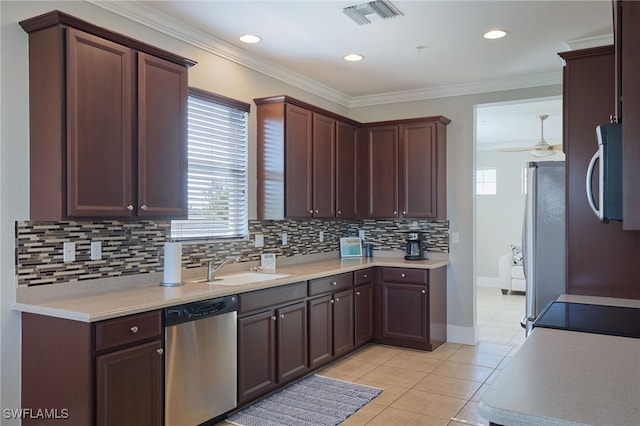 kitchen featuring crown molding, light tile patterned floors, sink, and appliances with stainless steel finishes