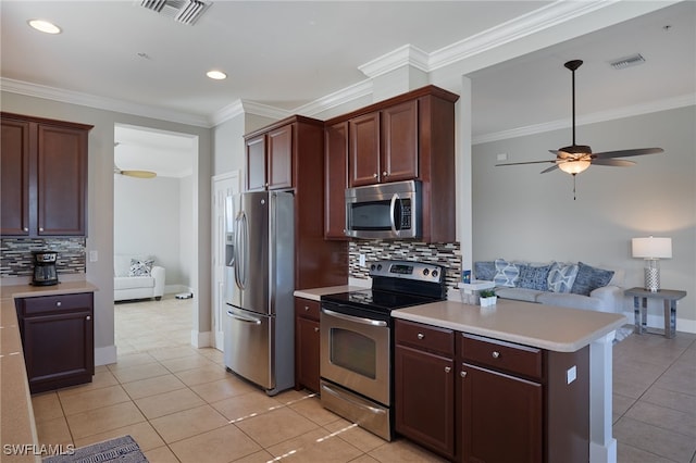 kitchen featuring decorative backsplash, ceiling fan, light tile patterned floors, and appliances with stainless steel finishes