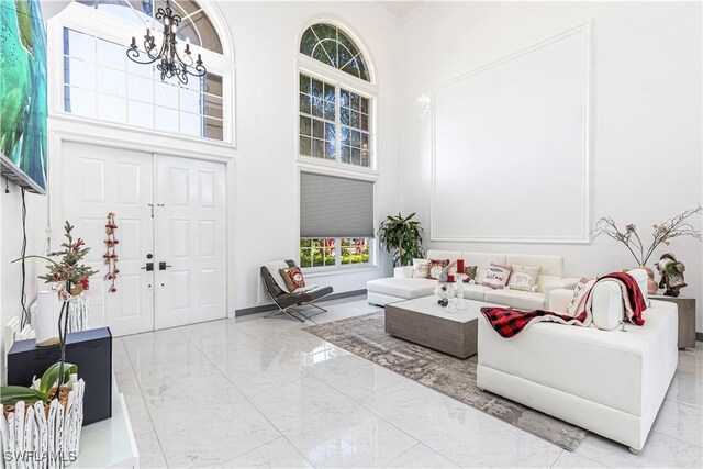 living room with a high ceiling and a chandelier